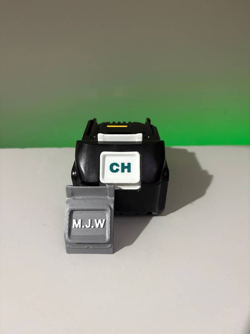 Multiple custom battery buttons in mixed colours fitted to Makita DeWalt Milwaukee batteries for crew tool marking